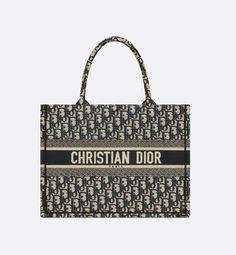 Introduced by Maria Grazia Chiuri, Creative Director of Christian Dior, the Dior Book Tote has become a staple of the Dior aesthetic. Designed to hold all the daily essentials, the style is fully embroidered with the ecru and blue Dior Oblique motif. Adorned with the Christian Dior Paris signature on the front, the medium tote exemplifies the House's signature savoir-faire and may be carried by hand or worn over the shoulder.. Blue Dior, Dior Aesthetic, Christian Dior Logo, Dior Book, Christian Dior Paris, Dior Paris, Dior Oblique, Book Tote Bag, Dior Logo