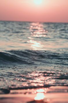 the sun shines brightly over the ocean as it reflects off the water's surface