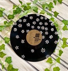 a black record with white flowers on it