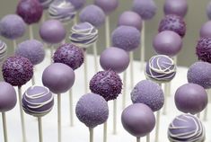 cake pops with purple and white frosting on them