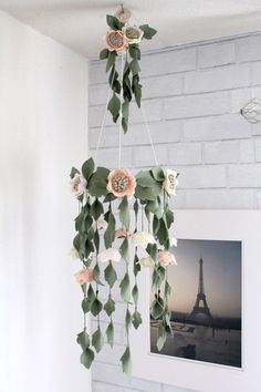 a white brick wall with flowers hanging from it