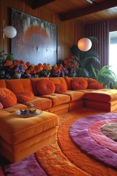 a living room filled with orange couches and colorful rugs