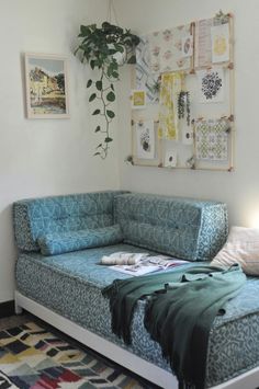 a living room with a couch, rug and pictures hanging on the wall above it