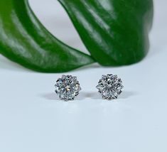 Looking for a truly timeless and elegant gift for the special woman in your life? Consider our Certified VVS1 Moissanite Solitaire Stud Earrings, the perfect accessory for any occasion. These stunning earrings feature high-quality moissanite stones in brilliant cuts and are available in two sizes: 1.0 Ct (5mm) or 2.0 Ct (6.5mm). The stones are set in durable rhodium-plated sterling silver, ensuring a lustrous shine that will last for years to come. Moissanite is a gemstone that closely resembles diamonds but with a higher level of brilliance and fire. The VVS1 clarity grade indicates that these stones have very few inclusions, making them extremely clear and sparkly. These earrings are certified by a third-party gemological laboratory, ensuring their authenticity and quality. The stones ar Gift Moissanite Diamond Earrings Gia Certified, Gia Certified Moissanite Diamond Earrings For Gift, Gia Certified Silver Diamond Earrings For Gift, Platinum Diamond Earrings With Halo Design As Gift, Gia Certified 14k White Gold Diamond Earrings For Anniversary, Classic Moissanite Earrings With Halo Design, Timeless Moissanite Earrings For Anniversary, Gift Diamond Earrings With Round Stone, Gia Certified Diamond Earrings Fine Jewelry Gift