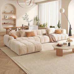 a living room filled with furniture and lots of windows