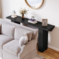 a living room with a couch, table and mirror