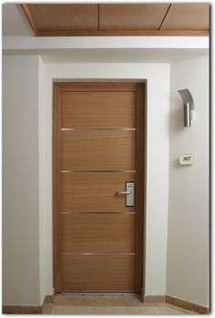 a wooden door in the corner of a room