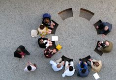 several people sitting in a circle around each other