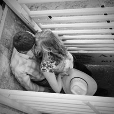 black and white photograph of two people sitting on the ground