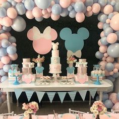 a table topped with lots of cake and balloons