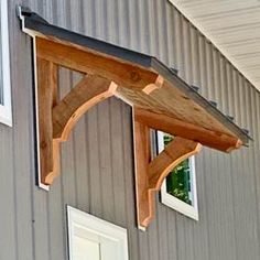 the corner of a building with a wooden window frame