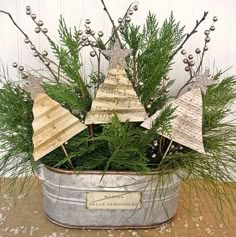 a tin can filled with christmas trees on top of a table