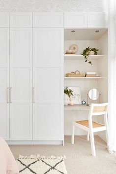 a bedroom with white closets and shelves in it