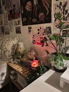 a living room with plants and pictures on the wall