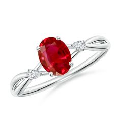 a ring with an oval ruby stone and two diamonds on the side, set in white gold