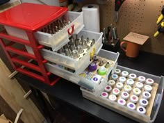 an assortment of crafting supplies sitting on a workbench with tools in it