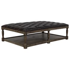 an old style coffee table with tufted upholstered leather and wooden legs,