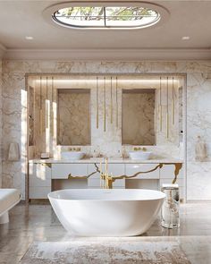 an elegant bathroom with marble walls and flooring, large bathtub next to two sinks