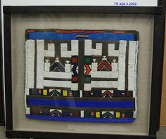 an art piece is on display in a black frame with white and blue trims