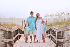 a family poses for a photo on the beach