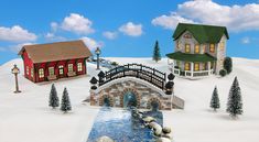 a small bridge over a river next to a house on top of a snow covered hill