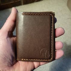 a person is holding a wallet in their hand