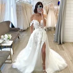 a woman taking a selfie in her wedding dress while she is looking into the mirror