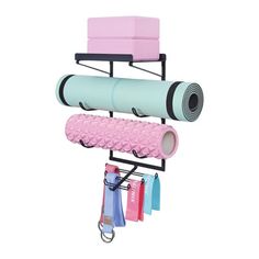 a pink and blue yoga mat hanging from a rack with two different colors on it