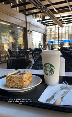 a tray with a piece of cake on it and a cup of coffee next to it