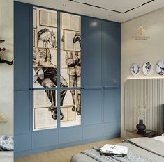 a bedroom with blue walls and pictures on the wall