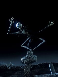 a skeleton standing on top of a rock in the dark