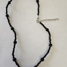 Nwot, Black Multi-Size Beaded Necklace. This Necklace Measures 18.5 In That Can Extend Another 2.5 In. This Does Have A Silver Extension And A Silver Lobster Claw Closure. The Larger Bead Measures .5" Around And Is Multi-Faceted. The Smaller Beads Are 1/8" And Are Various Sizes. I Ship Fast And Bundle When Asked. Comes From A Smoke Free Home. Please Contact Me With Any Questions. Adjustable Black Beaded Crystal Necklace, Adjustable Black Beaded Necklaces With Round Beads, Black Single Strand Beaded Necklaces For Party, Black Single Strand Beads For Jewelry Making, Black Single Strand Beaded Necklace For Party, Party Black Single Strand Beaded Necklace, Adjustable Black Necklaces With Faceted Beads, Black Beaded Chain Choker With Round Beads, Adjustable Single Strand Black Choker