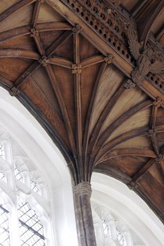 an ornate wooden ceiling in a large building