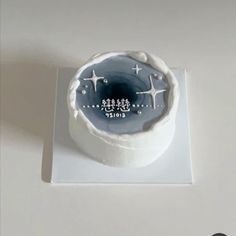 a white cake with blue frosting and stars on it