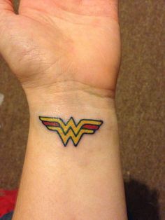 a small wonder woman tattoo on the wrist