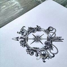 a drawing of an arrow and compass on paper