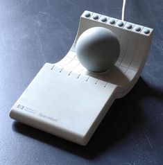 a white object sitting on top of a table next to a string attached to it