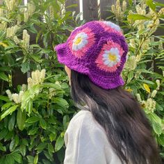 A beautiful crocheted granny square bucket hat.  Handmade in Ireland. All hats are handmade by myself once ordered.  Modelled by myself :) 100% acrylic soft yarn.  Vegan-friendly.  Available in the following sizes:  0-3 months (newborn) 3-6 months (baby) 6-12 months (baby) 1-2 years (toddler) 2-5 years (child) 5-12 years (child) 13-18 years (teen)  18 years+ (woman)  18 years+ (man) Purple Bohemian Yarn Hat, Bohemian Granny Square Yarn Hat, Bohemian Granny Square Crochet Hat, Adjustable Granny Square Crochet Bucket Hat, Winter Festival Crochet Bucket Hat, Winter Crochet Bucket Hat For Festivals, Adjustable Beanie With Granny Square Details, Purple Crochet Hat For Spring, Handmade Purple Crochet Hat For Spring