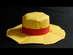 a yellow paper hat with a red band