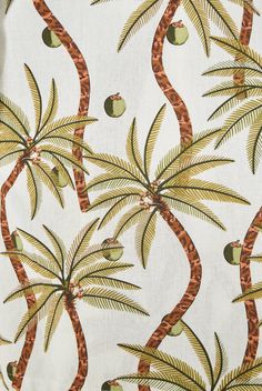 a white fabric with palm trees and apples on it's back side, printed in gold foil