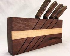 a wooden knife holder with five knives in it