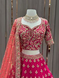 Unleash your bold side with our JUNE MADNESS ONLINE EXCLUSIVE- 013! This vibrant pink bridal wear features a stylish multicolor thread border with intricate butties all over the skirt. Complete the look with the peach orange dupatta, perfect for the daring sister of the bride or groom. Get ready to make a statement at any wedding or special occasion with this unique piece! Fabric: Raw Silk! WASH CARE INSTRUCTIONS - Please Dry clean only when it is applicable. Ready to Ship! Designer Silk Thread Lehenga For Festivals, Embroidered Kundan Choli For Party, Designer Wear Pink Silk Thread Choli, Embellished Lehenga With Saree Shape And Multicolor Embroidery, Traditional Embellished Raw Silk Lehenga, Bollywood Silk Thread Lehenga With Dori Work, Festive Embellished Lehenga With Multicolor Embroidery, Embellished Multicolor Embroidery Lehenga For Festive Occasions, Bollywood Silk Lehenga With Dori Work