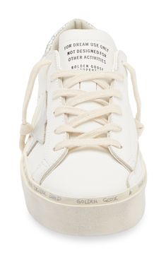 A metallic star and glittery counter dazzle on a leather sneaker detailed with a prescuffed platform sole and handwritten logo lettering around the foxing. Lace-up style Leather upper/leather and textile lining/rubber sole Made in Italy Designer Shoes White Leather Sneakers With Foil Embossed Logo, Golden Goose Hi Star, Handwritten Logo, Top Sneakers Women, Golden Goose Deluxe Brand, Golden Goose, Up Styles, White Silver, Leather Sneakers