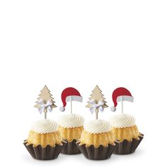 three cupcakes with christmas decorations on top