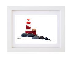 a painting of a lighthouse and rocks in a white frame