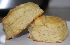 two biscuits sitting on top of a white plate