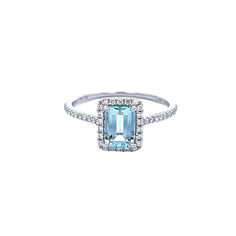 an aqua and white gold ring with diamonds on the sides, set in 18k white gold