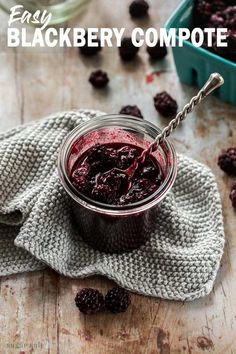 homemade blackberry compote in a glass jar with berries around it and text overlay reading easy blackberry compote