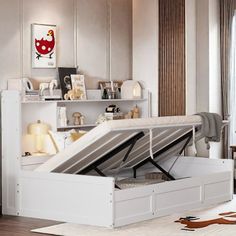 a white bed with an open storage compartment underneath it