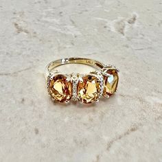 Beautiful 14 karat yellow gold cocktail ring featuring 3 natural oval citrines. The gemstones weigh approximately 3.6 carats, and are accented by 20 diamonds weighing approximately 0.08 CTTW. Citrine is the birthstone for November! Weighs 3.3 grams. Size 7 US / N 1/2 - O UK. > Resizing included. This ring can be resized to fit most fingers. Please contact us for details. Resized rings are final sale. Free resizing does not apply to discounted rings over 15% off. Birthstone: November/April. Condi Oval Citrine Birthstone Ring, Oval Yellow Citrine Birthstone Ring, Oval Yellow Gold Topaz Ring With Diamond Accents, Elegant Yellow Oval Birthstone Ring, Yellow Oval Birthstone Anniversary Ring, Oval Yellow Birthstone Anniversary Ring, Oval Yellow Gold Birthstone Anniversary Ring, Oval Citrine Birthstone Ring For Anniversary, Oval Yellow Topaz Ring With Accent Stones